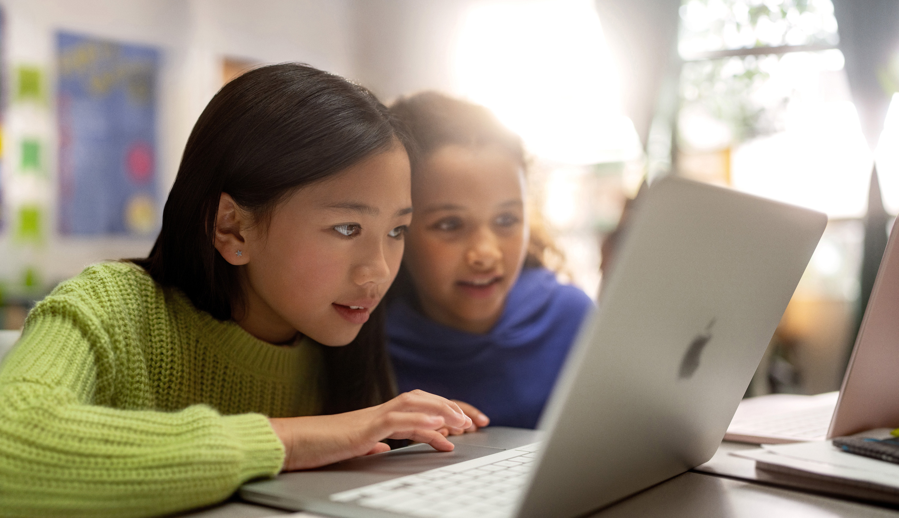 Students learning together with laptops in a classroom